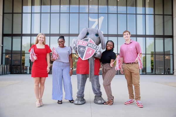 A picture of students doing poses smiling